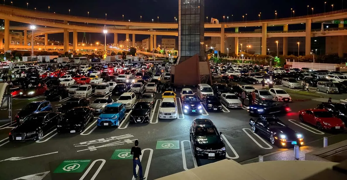 Crowd of tuned sports cars gathered at the Daikoku PA meet on a daikoku pa tour near Tokyo